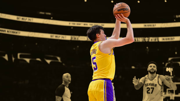 Los Angeles Lakers guard Austin Reaves (15) shoots a three-point basket