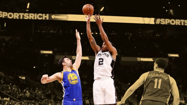 Mar 29, 2017; San Antonio, TX, USA; San Antonio Spurs small forward Kawhi Leonard (2) shoots the ball over Golden State Warriors center Zaza Pachulia (27) during the first half at AT&T Center.